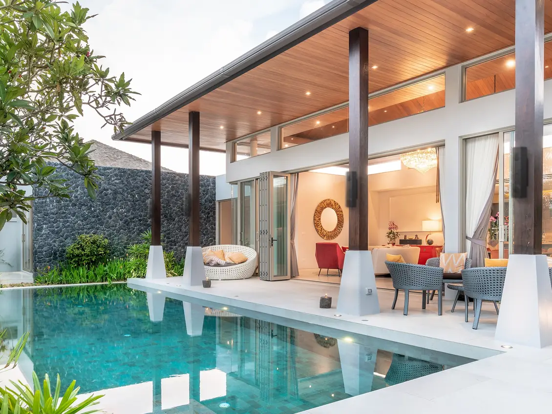 A pool and covered terrace with Lithe Audio iO1 outdoor speakers mounted on the posts
